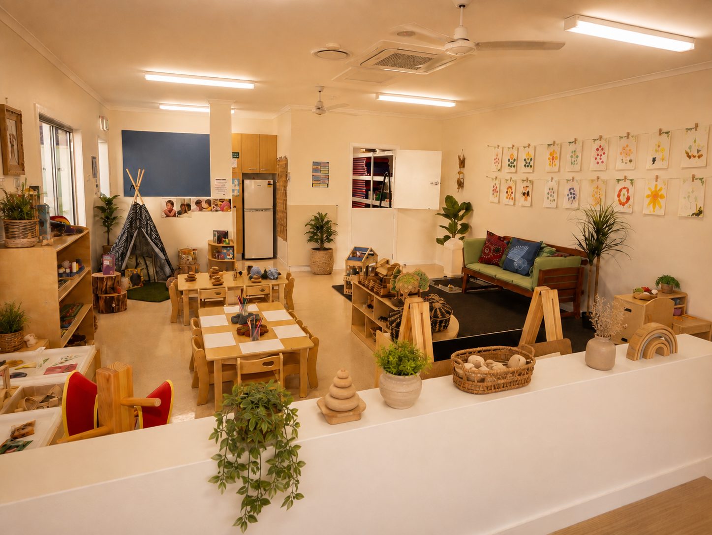Toddler 2 learning environment at Xplor Coomera with a play teepee, chalkboard wall and children's artwork on display